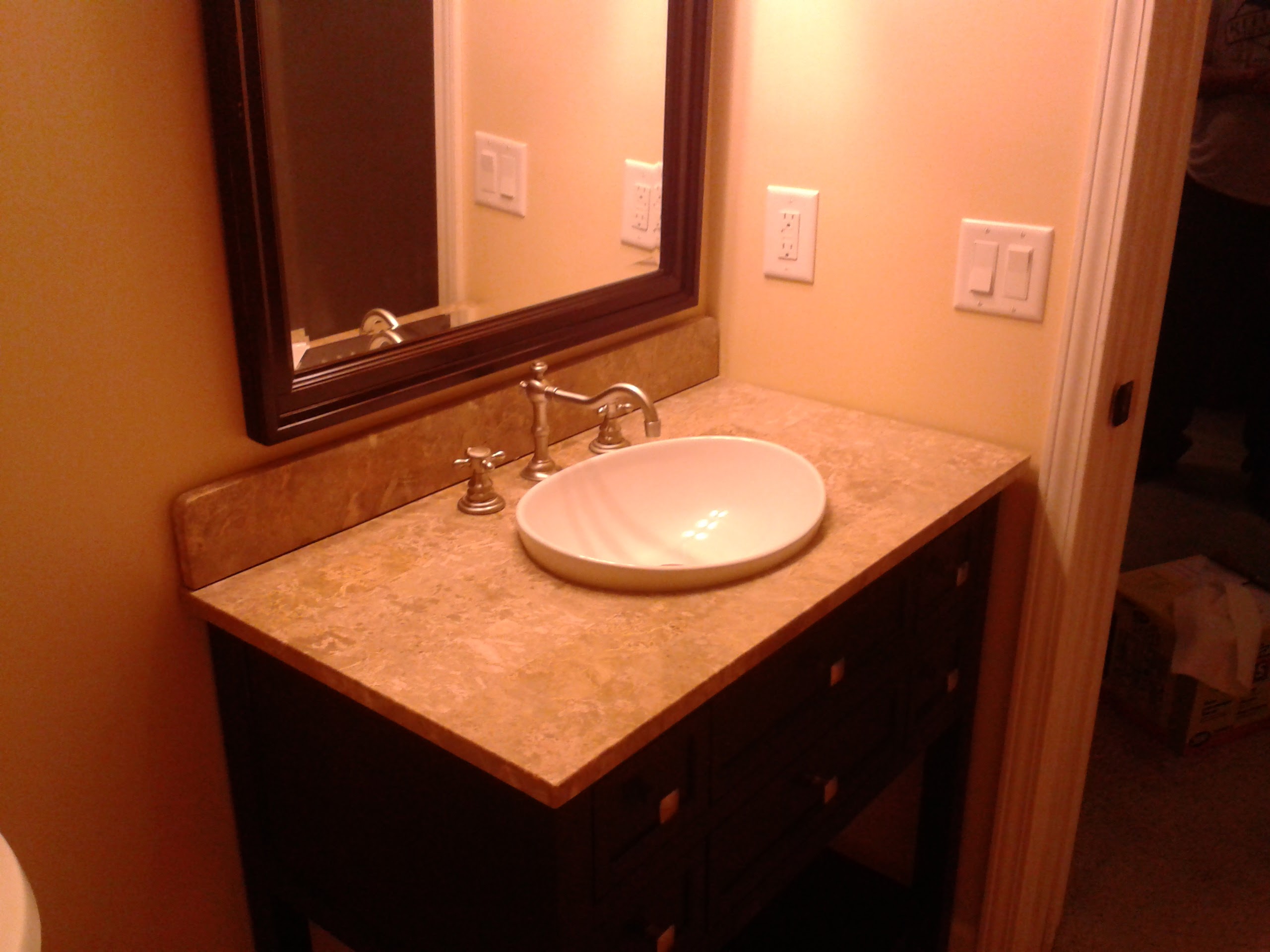 Completed bathroom vanity with marble countertop and vessel sink