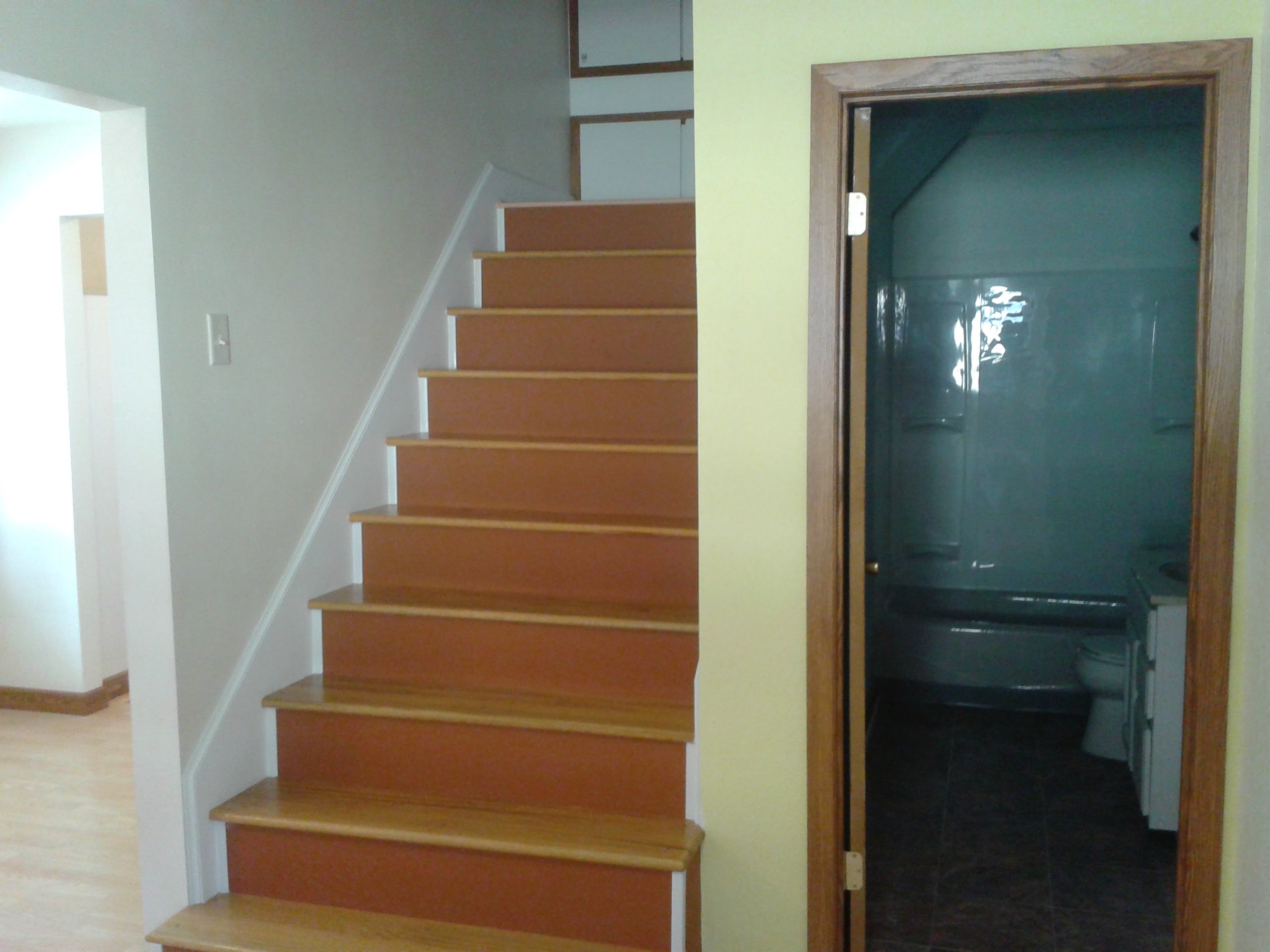 Completed staircase with oak treads, white risers, and finished hallway