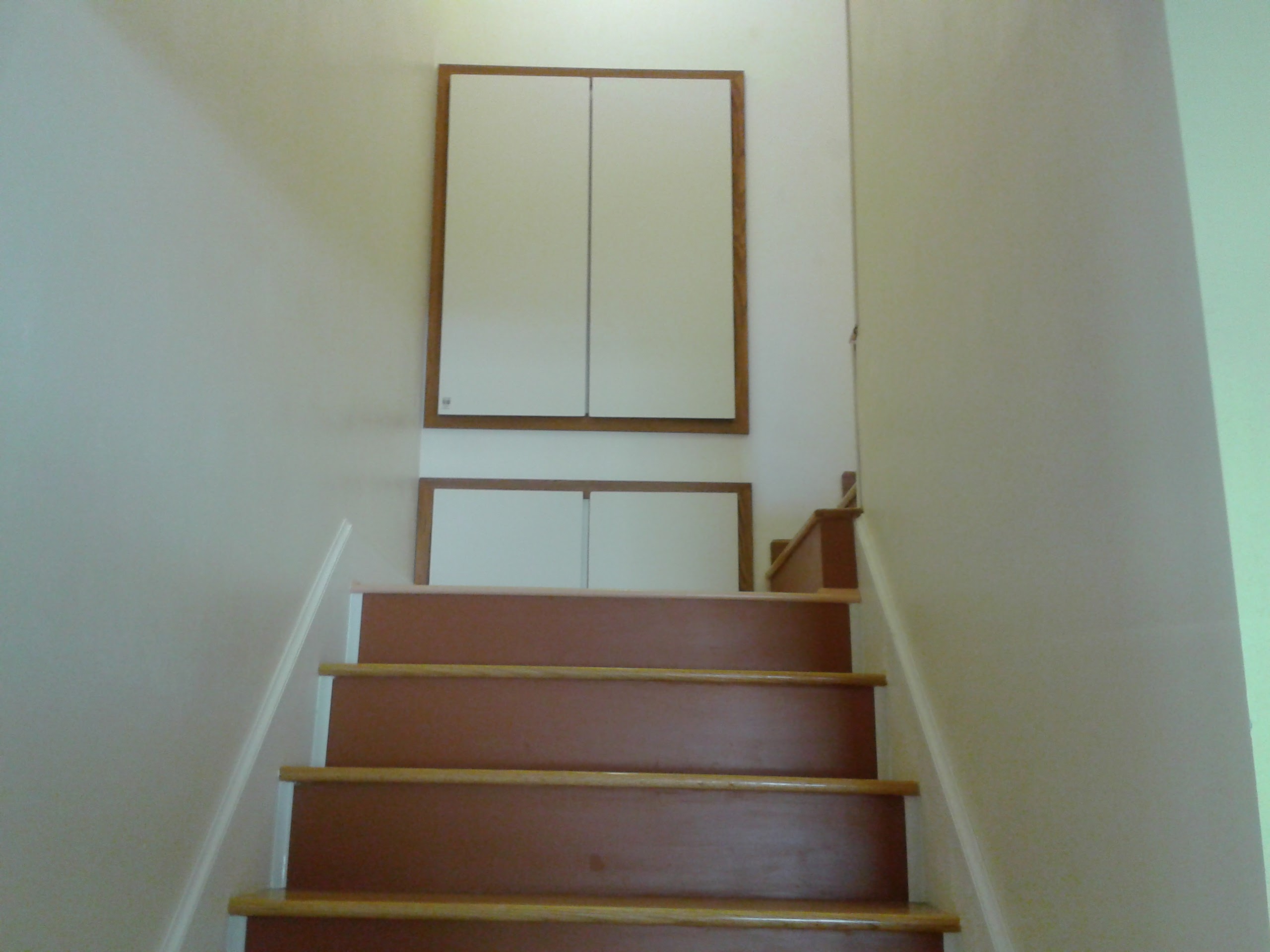 Completed staircase viewed from bottom showing oak treads and upper landing