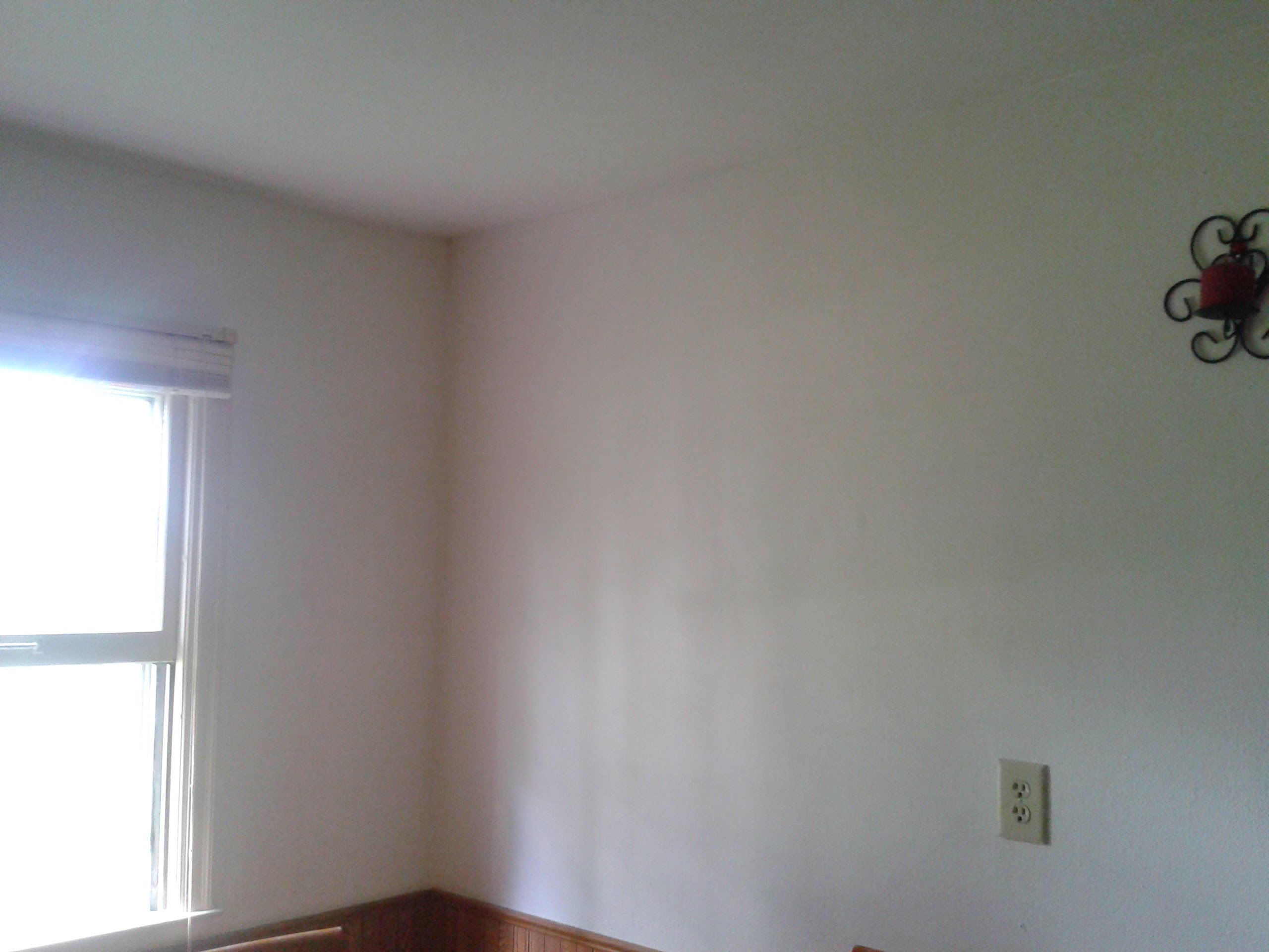 Completed water damage repair with fresh drywall and paint