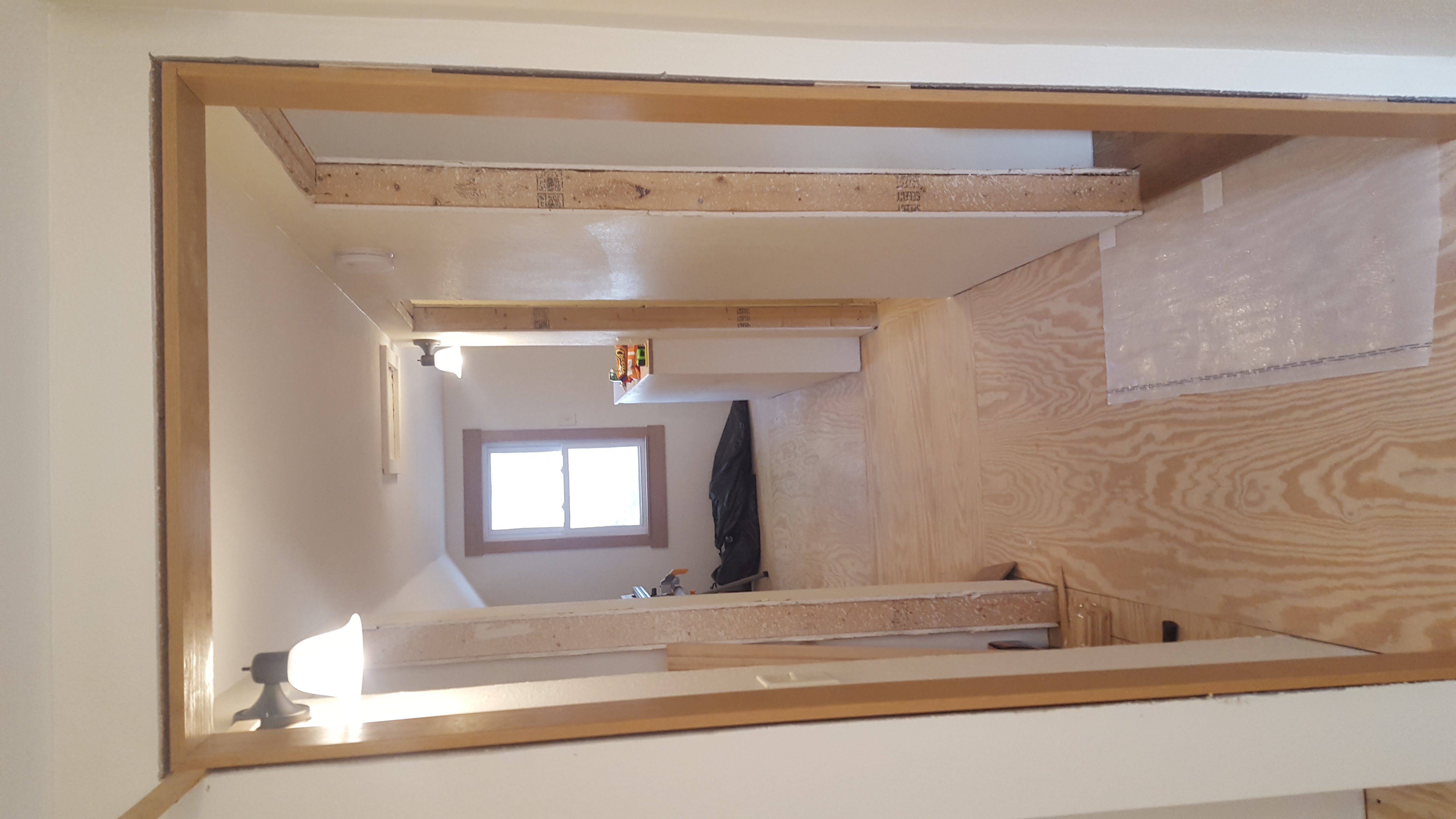 Upper floor framing and plywood walls during remodel