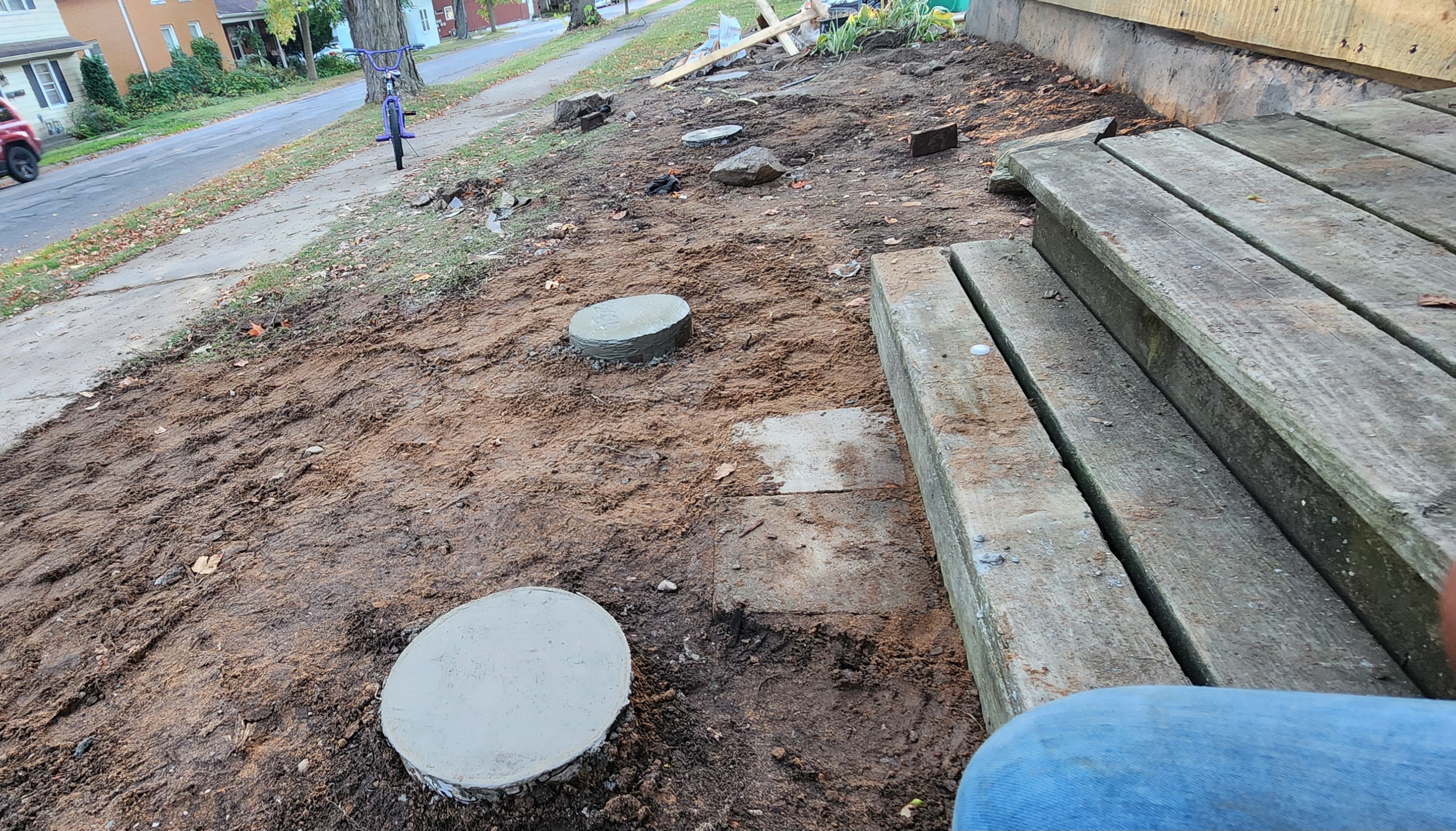 Concrete footings set and old steps removed during porch foundation work