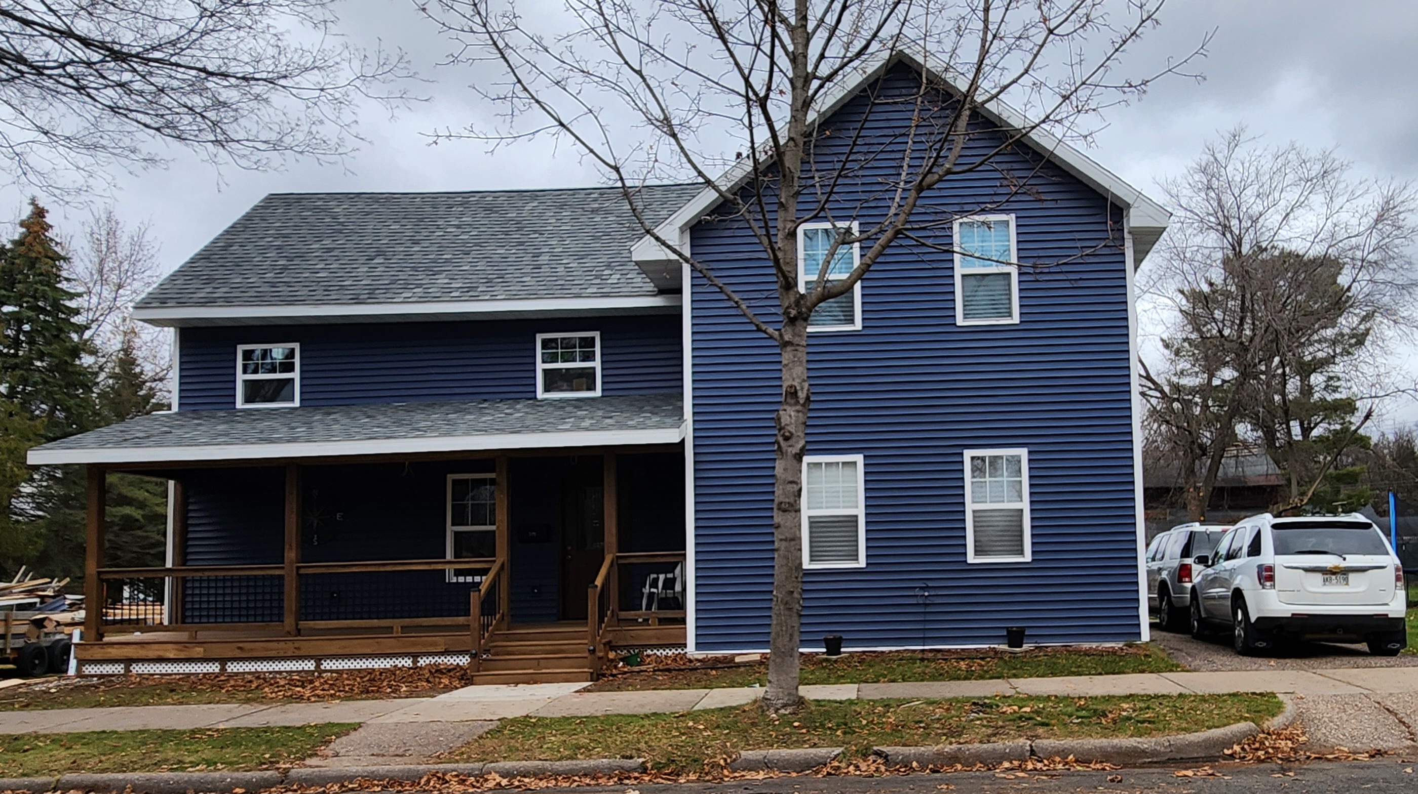 Completed exterior with new blue siding and covered front porch