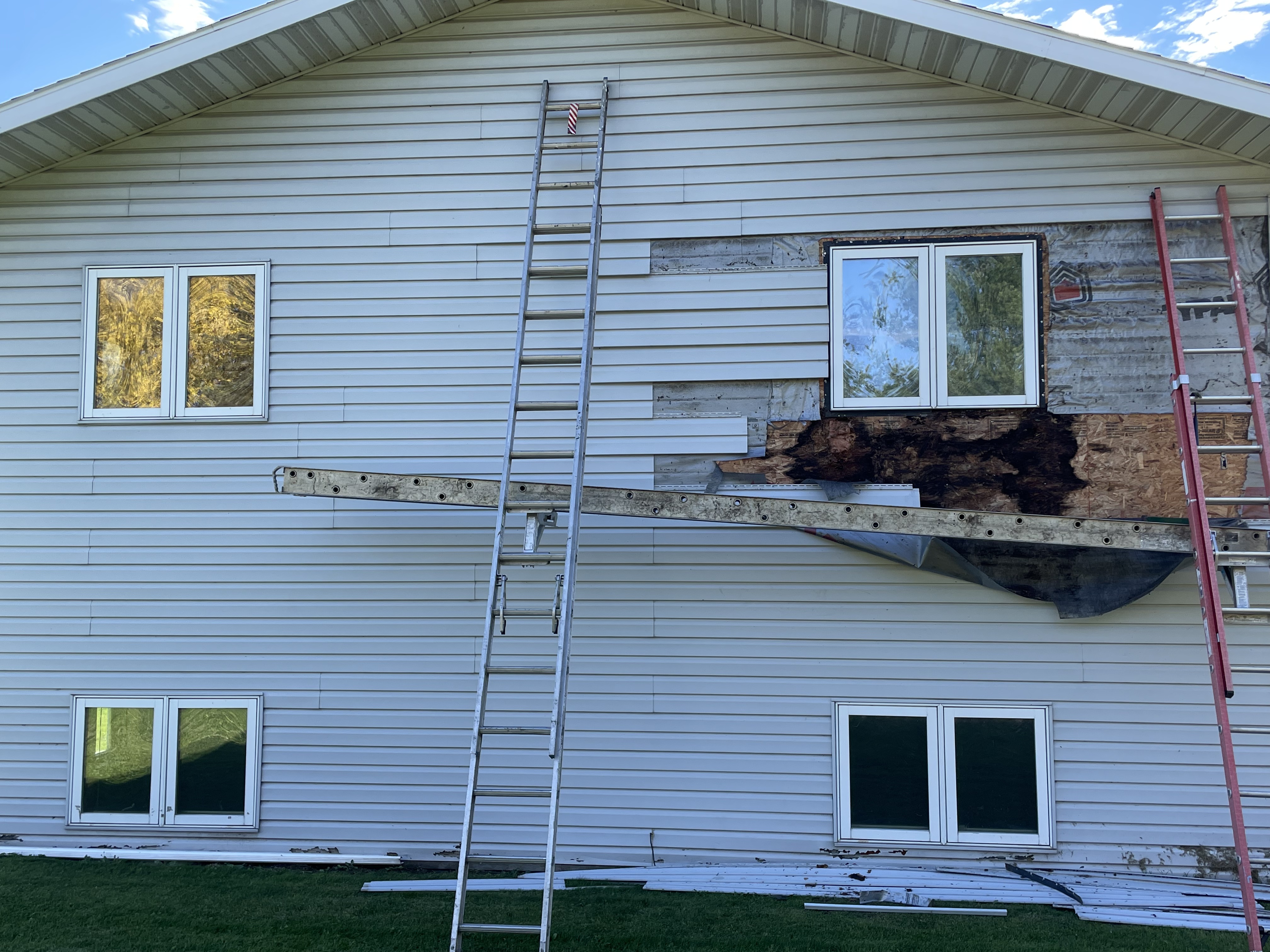 Rot damage discovered in sheathing and framing during siding tear-off