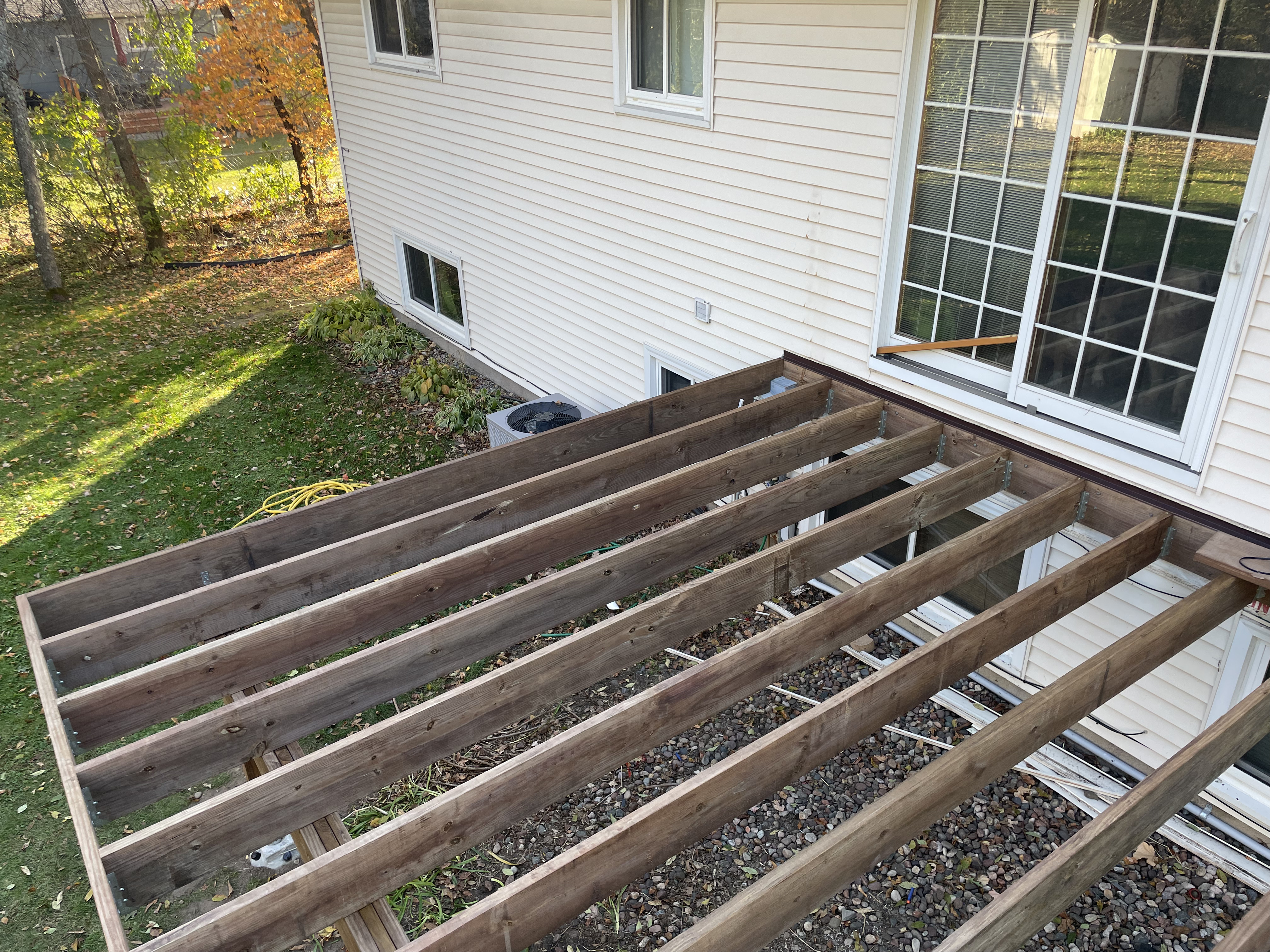Deck framing with joists exposed during new deck construction
