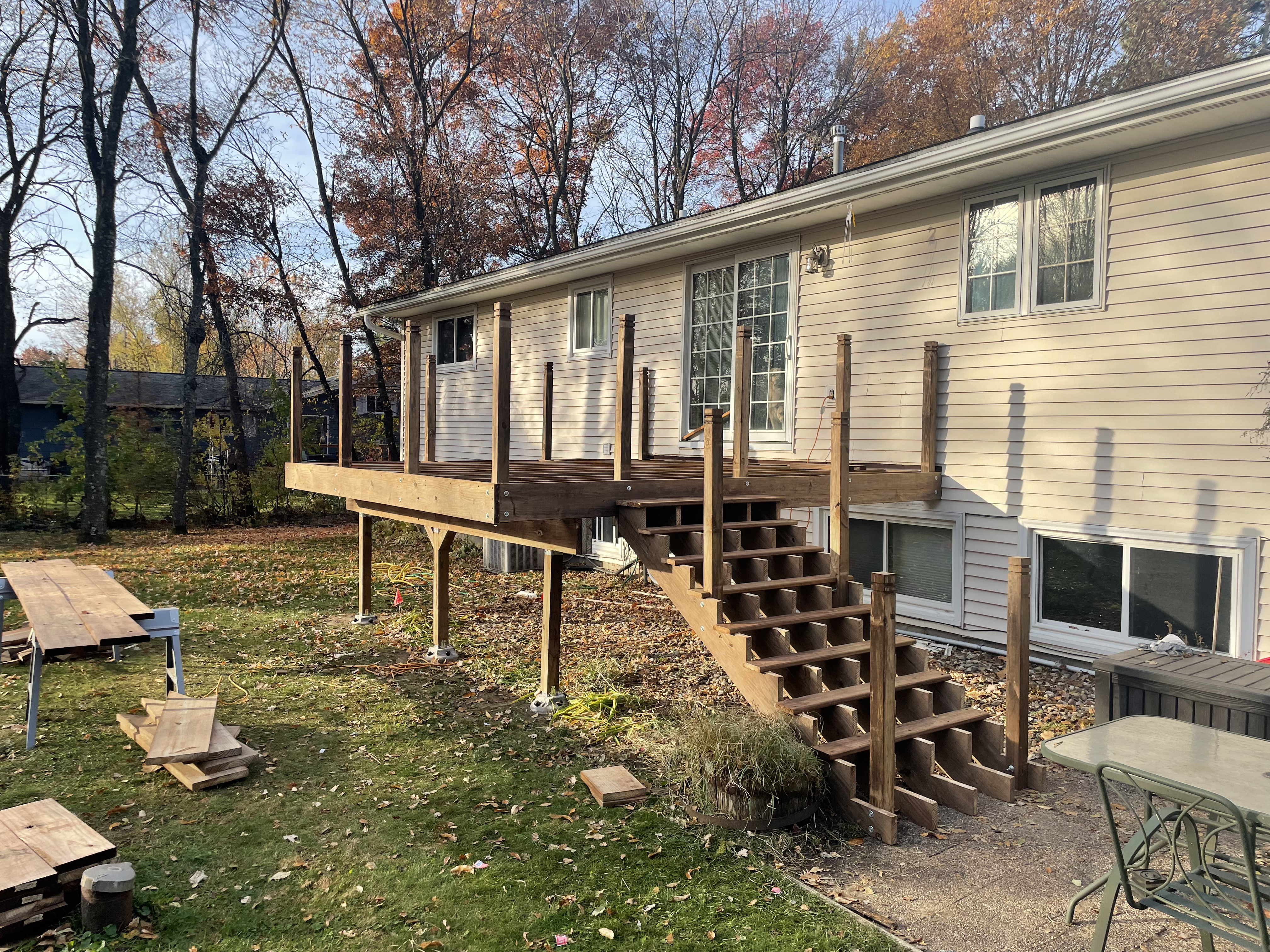 New deck structure with stairs and railing posts during construction