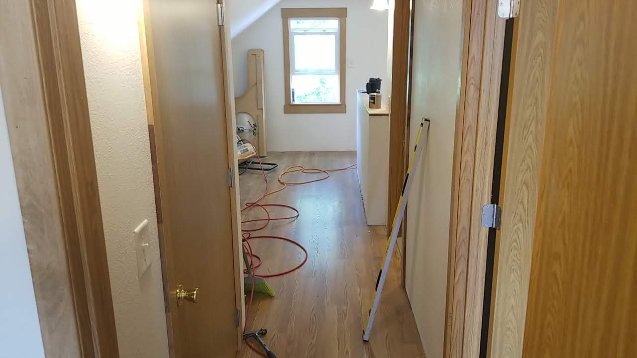Hallway with new hardwood floors and interior doors installed