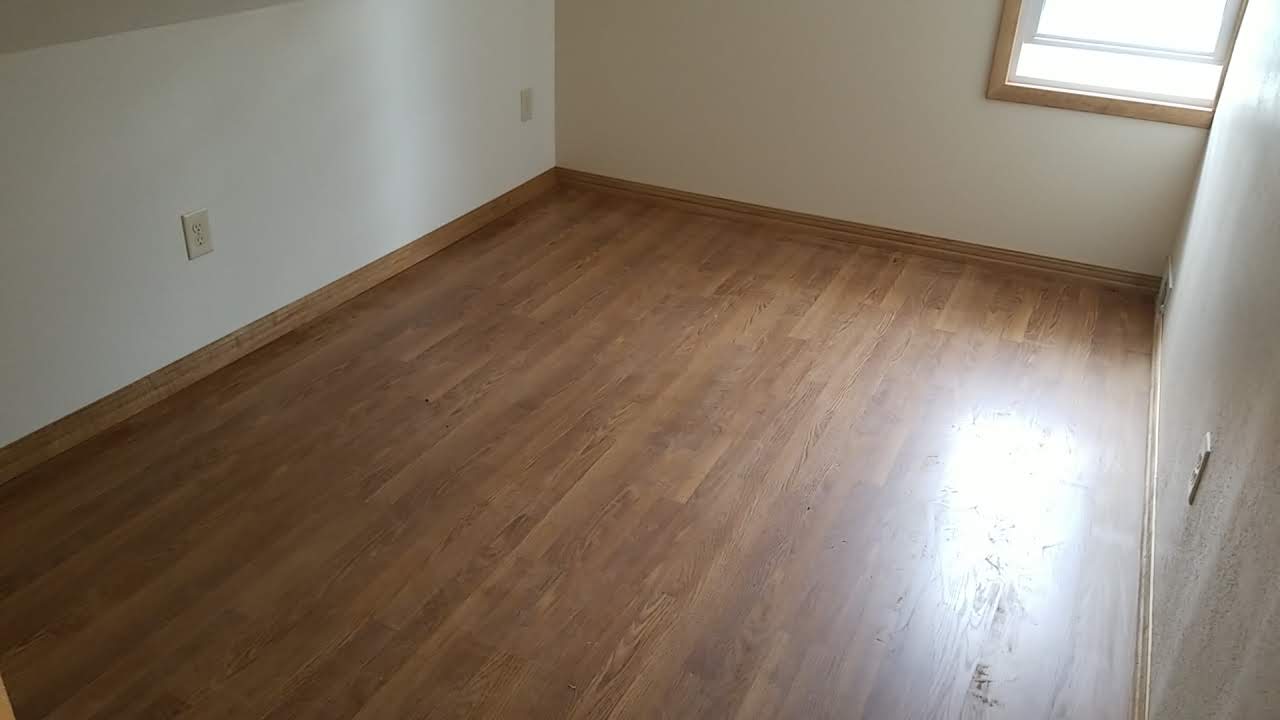 Completed upper floor bedroom with hardwood floors and natural light